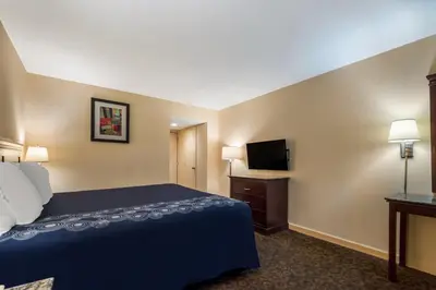 a hotel room with a bed and a flat screen tv at Knights Inn Phildelphia in Philadelphia