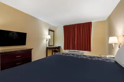 a hotel room with a large bed and a television at Knights Inn Phildelphia in Philadelphia