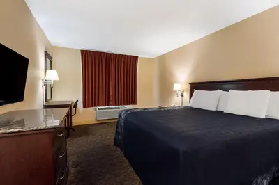 a hotel room with a bed and a television at Knights Inn Phildelphia in Philadelphia