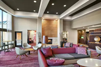 a lobby with a couch and chairs and a fireplace at Courtyard Philadelphia/Langhorne in Langhorne