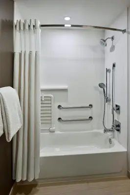 a bathroom with a bath tub with a shower curtain at Courtyard Philadelphia/Langhorne in Langhorne
