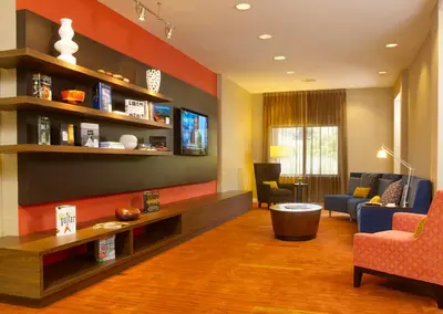 a living room with a couch and a tv at Courtyard Philadelphia/Langhorne in Langhorne