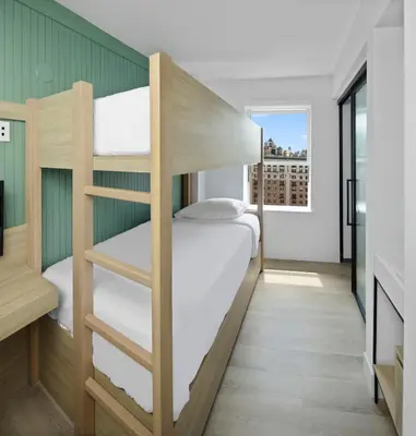 a small room with bunk beds in it at Riverside Tower Hotel in New York