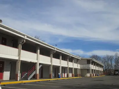 an empty parking lot in front of a building at Red Carpet Inn - New Brunswick in New Brunswick