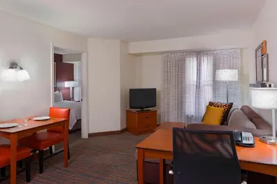 a living room with a couch and a table and a television at Residence Inn by Marriott Philadelphia Montgomeryville in North Wales