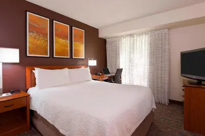 a hotel room with a bed and a flat screen tv at Residence Inn by Marriott Philadelphia Montgomeryville in North Wales