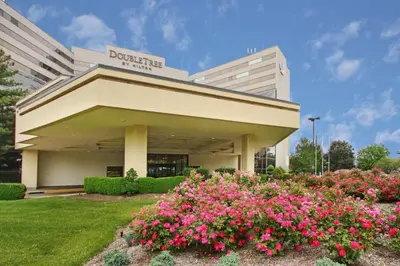 a building with pink flowers in front of it at DoubleTree by Hilton Hotel Newark Airport in Newark