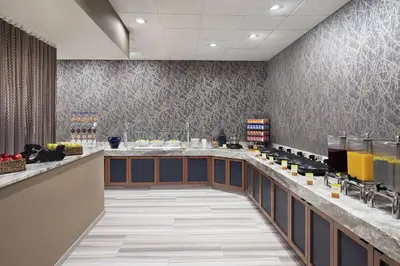 a restaurant with a long counter in a room at DoubleTree by Hilton Hotel Newark Airport in Newark