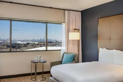 a hotel room with a bed and a large window at DoubleTree by Hilton Hotel Newark Airport in Newark