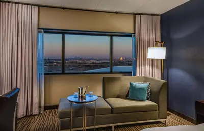 a room with a chair and a table and a window at DoubleTree by Hilton Hotel Newark Airport in Newark