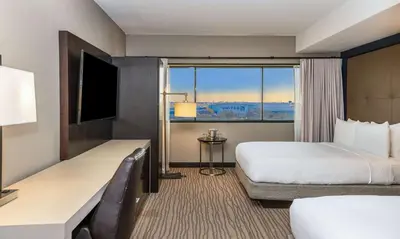 a hotel room with a bed and a large window at DoubleTree by Hilton Hotel Newark Airport in Newark