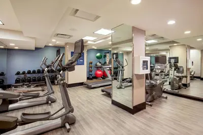 a gym with treadmills and ellipticals in a room at Four Points by Sheraton Midtown - Times Square in New York