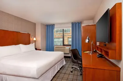 a hotel room with a bed and a flat screen tv at Four Points by Sheraton Midtown - Times Square in New York