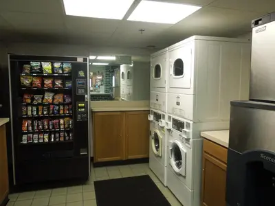 a large kitchen with a washer and dryer in at Days Inn by Wyndham Harrisburg North in Harrisburg