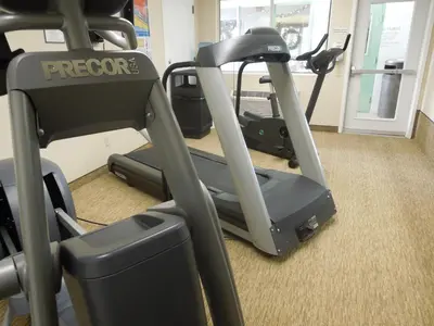 a gym with an exercise bike and a treadmill at Days Inn by Wyndham Harrisburg North in Harrisburg