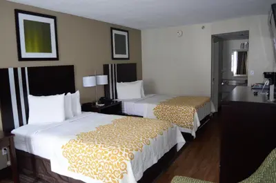 a hotel room with two beds and a bathroom at Days Inn by Wyndham Harrisburg North in Harrisburg