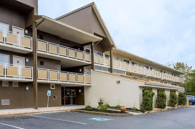 a building with a parking lot in front of it at Days Inn by Wyndham Harrisburg North in Harrisburg