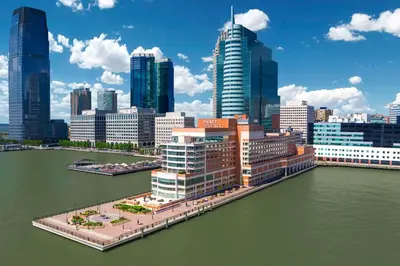 a view of a city with a river and buildings at Hyatt Regency Jersey City on the Hudson in Jersey City