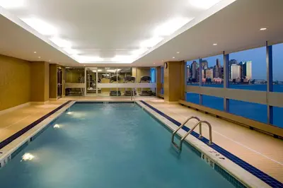 a pool in a hotel with a view of the city at Hyatt Regency Jersey City on the Hudson in Jersey City