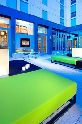 a building with a green bench in front of it at Aloft Mount Laurel in Mount Laurel
