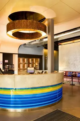 a lobby with a colorful counter in a building at Aloft Mount Laurel in Mount Laurel