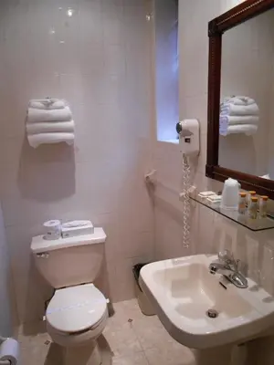 a bathroom with a white toilet and a sink at Hotel 31 Extended Stay in New York