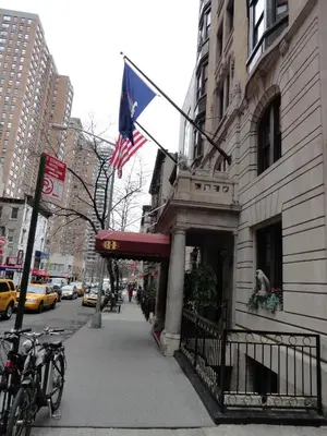 a building with an american flag on a street at Hotel 31 Extended Stay in New York