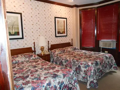 a hotel room with two beds and two windows at Hotel 31 Extended Stay in New York