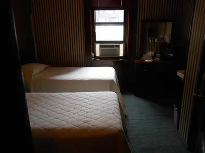a hotel room with two beds and a window at Hotel 31 Extended Stay in New York