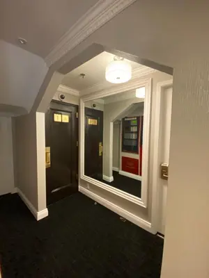 a hallway with a large mirror in a building at Hotel 31 Extended Stay in New York