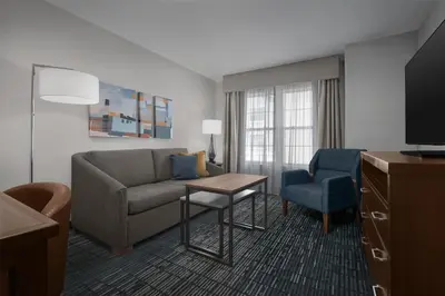 a living room with a couch and a chair at Homewood Suites by Hilton Newark-Cranford in Cranford