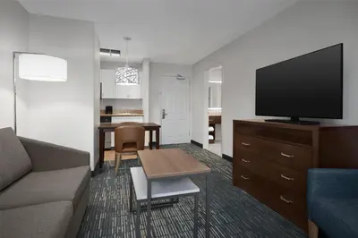 a living room with a couch and a flat screen tv at Homewood Suites by Hilton Newark-Cranford in Cranford
