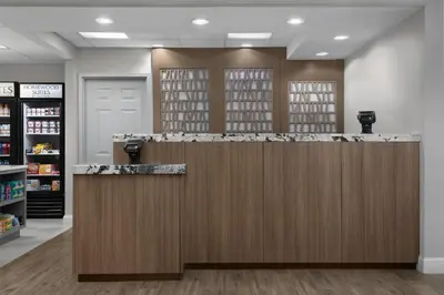 a lobby with a counter in a pharmacy at Homewood Suites by Hilton Newark-Cranford in Cranford