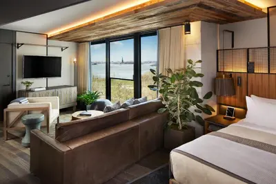 a hotel room with a couch and a bed at 1 Hotel Brooklyn Bridge in Brooklyn