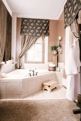 a large bathroom with a tub and a window at The Londonderry Inn in Hershey