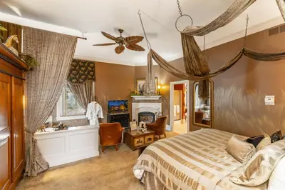 a bedroom with a bed and a fireplace at The Londonderry Inn in Hershey