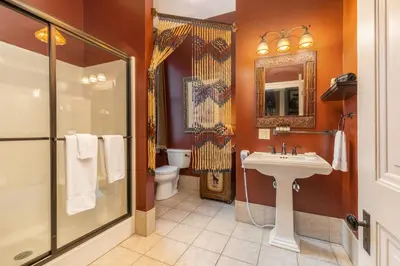 a bathroom with a toilet and a sink and a shower at The Londonderry Inn in Hershey