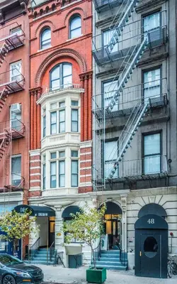 a large building with fire escapes on the side of it at Chelsea Inn in New York