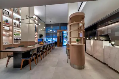 a kitchen with a long dining table and chairs at Citadines Connect Fifth Avenue New York in New York