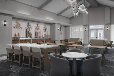a dining room with tables and chairs and a chandelier at Homewood Suites by Hilton Princeton in Princeton