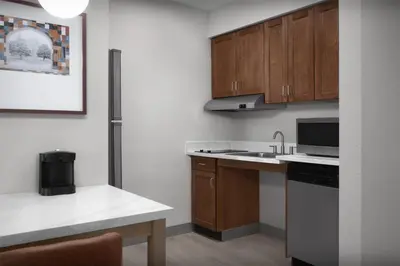 a kitchen with a sink and a microwave at Homewood Suites by Hilton Princeton in Princeton