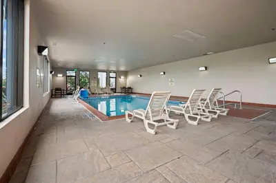 a swimming pool with lounge chairs and a swimming pool at Hampton Inn Ridgefield Park in Ridgefield Park