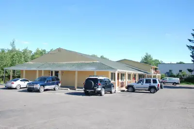 a building with cars parked in a parking lot at Mount Laurel Motel in Hazleton