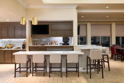 a kitchen with a large island with bar stools at Hilton Garden Inn Hershey in Hummelstown