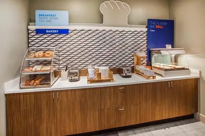 a bakery with a counter with donuts on it at Holiday Inn Express - Wall Street by IHG in New York