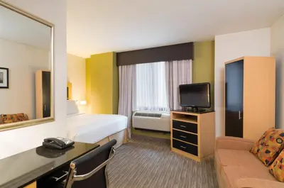 a hotel room with a bed and a television at Holiday Inn Express - Wall Street by IHG in New York