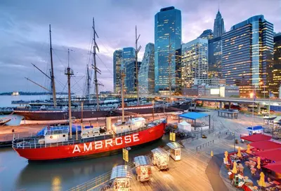 a red boat docked at a marina in a city at Holiday Inn Express - Wall Street by IHG in New York
