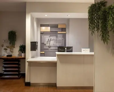a lobby with a counter with a clock on the wall at Holiday Inn Express - Times Square by IHG in New York