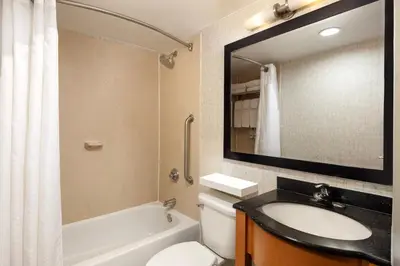 a bathroom with a sink and a toilet and a mirror at Holiday Inn Express - Times Square by IHG in New York