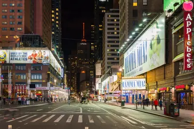 an empty city street at night with buildings at Holiday Inn Express - Times Square by IHG in New York